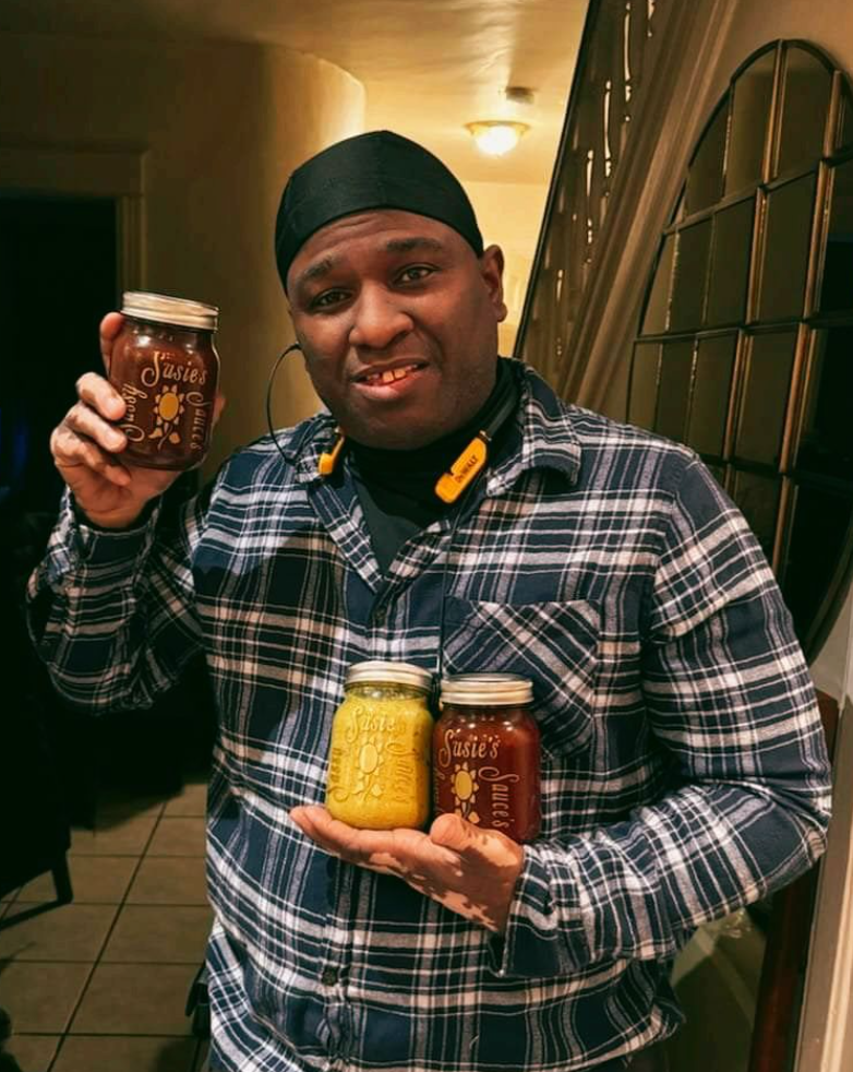 Man holding homemade preserves jars