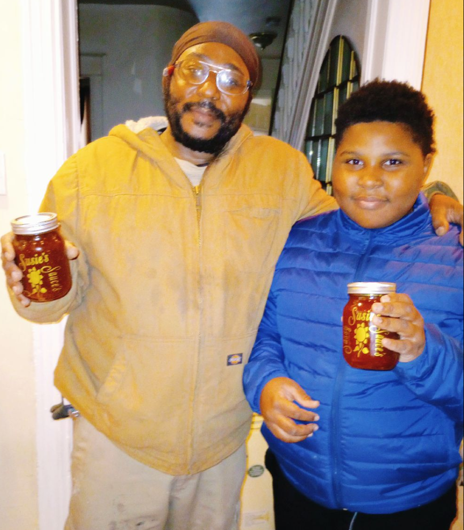 Two people holding jars indoors